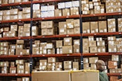 warehouse-worker-checking-inventory-managing-assets-min