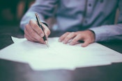 A person signing a lease agreement that complies with new lease accounting standards.