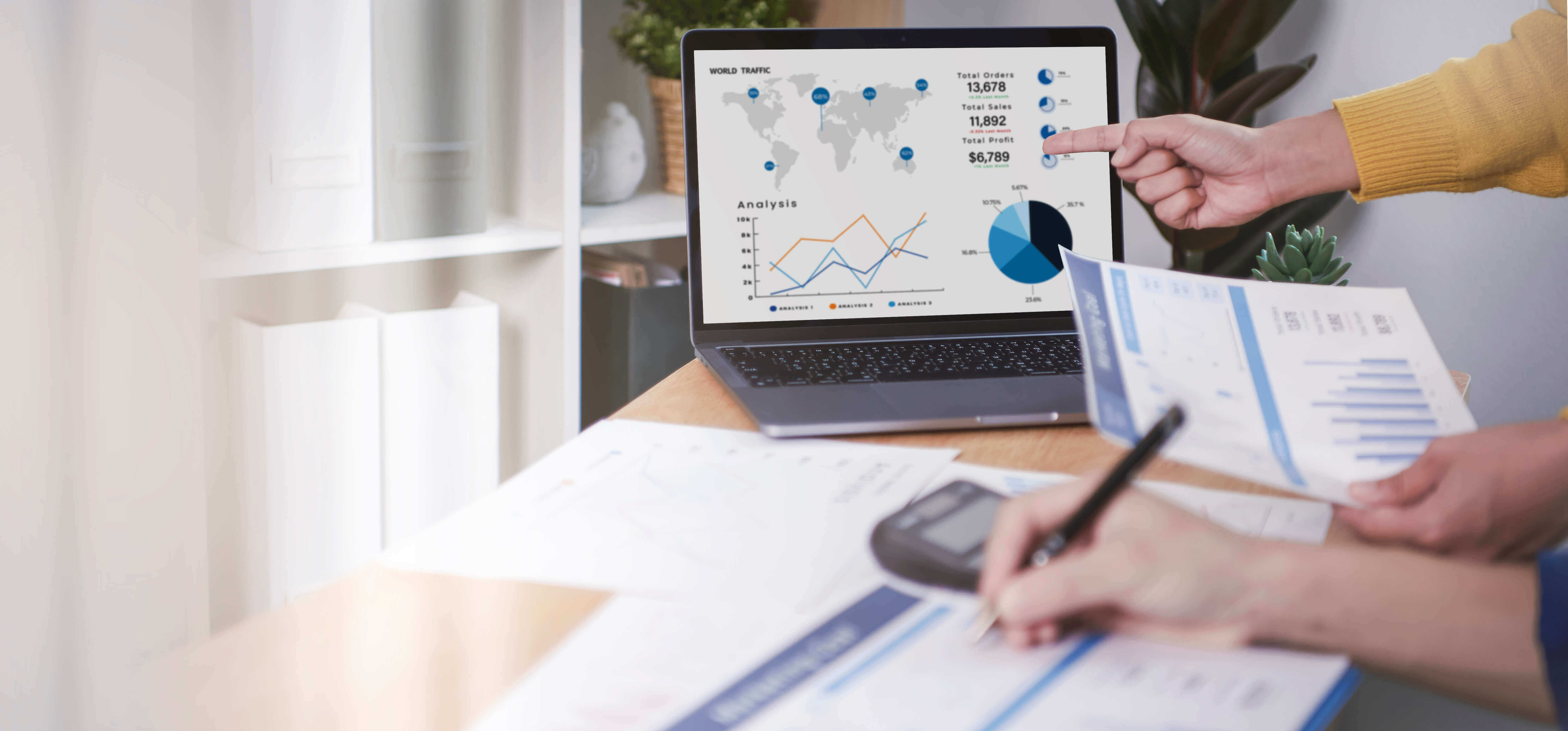 Person sitting at a desk working on a lease accounting financial report 