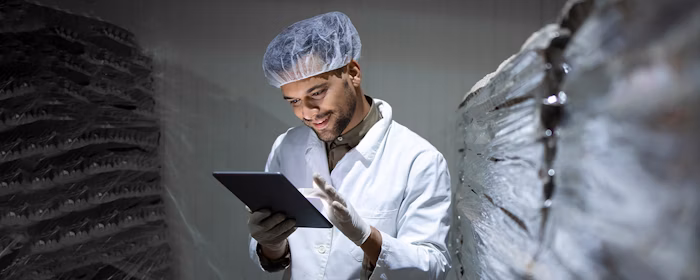 Worker in a lab coat using the Lx Contracts lease accounting software